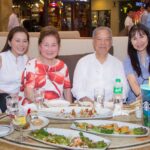 Dr. Lucio Tan and Ms. Carmen Tan enjoying the Tree Lighting with their daughters Vivian and Irene (L-R)
